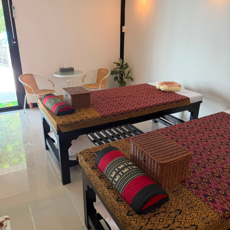 Traditional Thai massage beds with patterned textiles