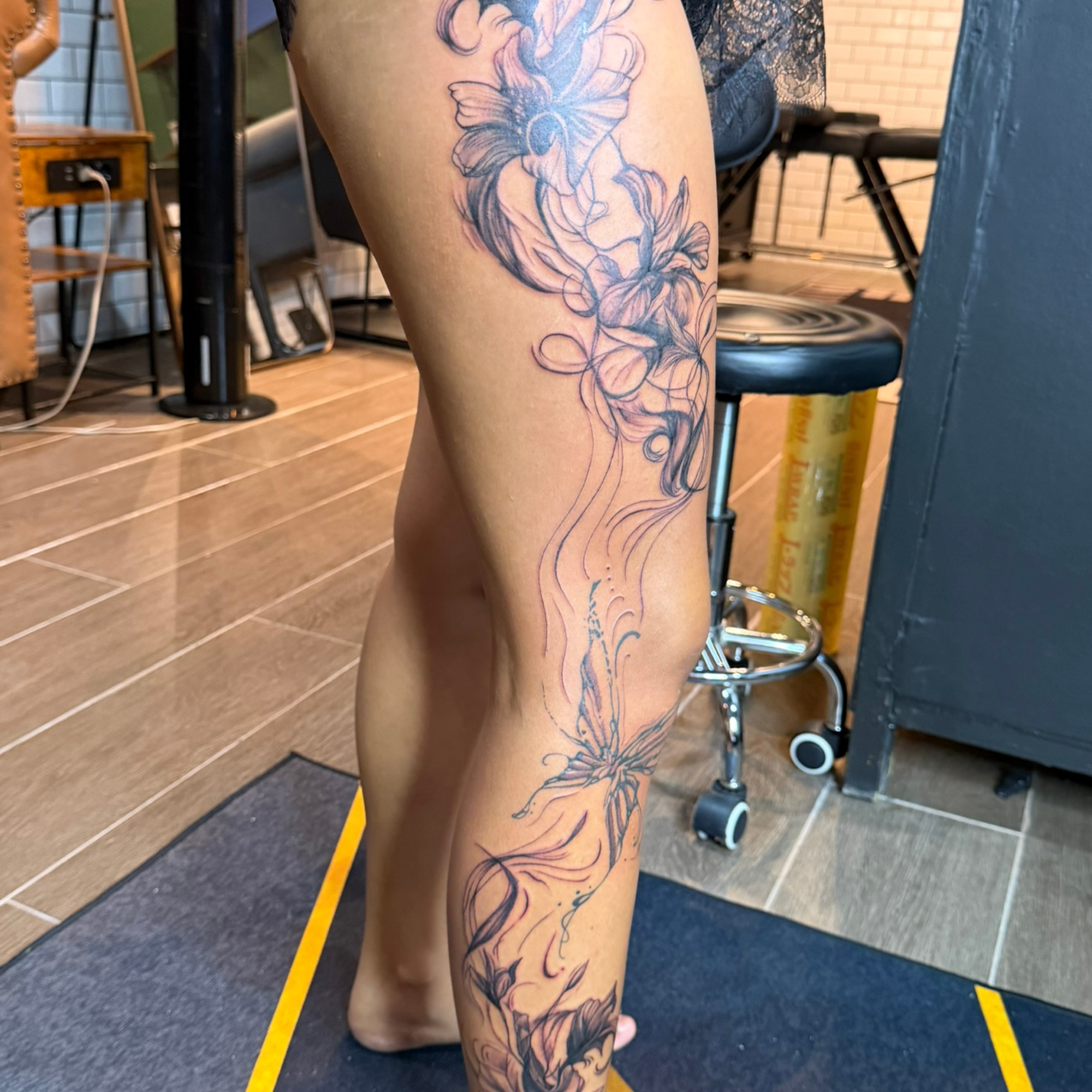 Finished black and grey floral leg sleeve tattoo