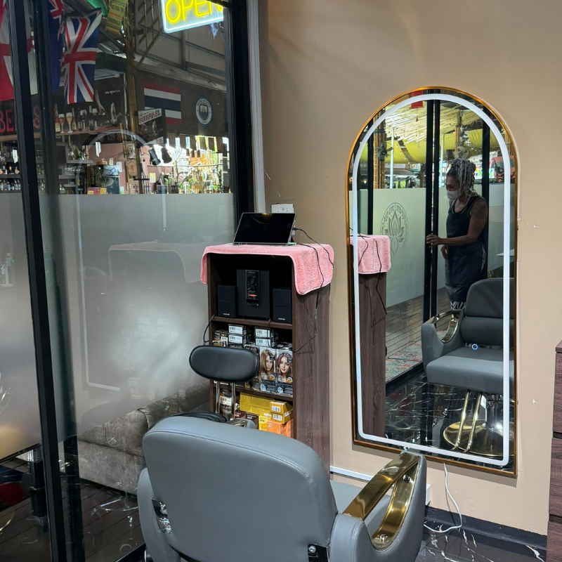Styling station with an arched lit mirror and product display